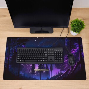 May include: A black and purple gaming mouse mat with a starry night forest scene. The mouse mat features a black keyboard and a black mouse.
