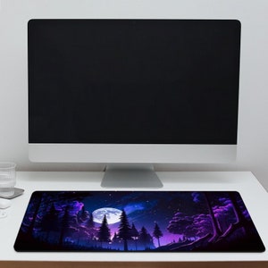 May include: A purple and blue mouse mat featuring a forest scene with a full moon in the background. The moon is white with a blue glow. The forest is dark with tall trees and a starry sky.