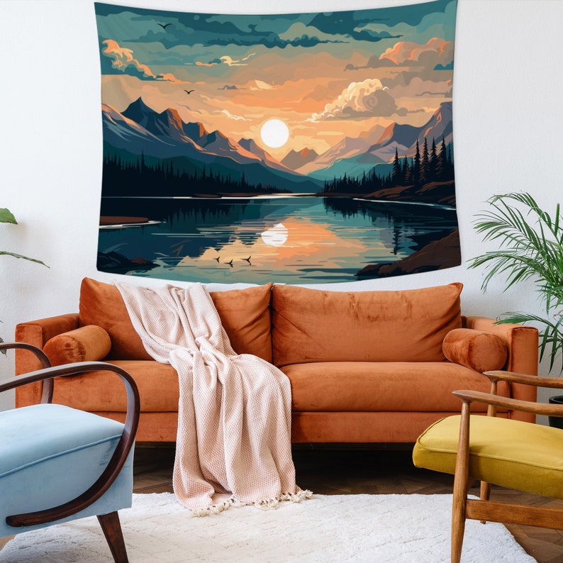 May include: A tapestry featuring a scenic landscape with a lake reflecting a sunset over mountains. The sky is a mix of blue, orange, and pink with fluffy clouds. The lake is a deep blue with a reflection of the sunset. The mountains are a dark silhouette against the sky.
