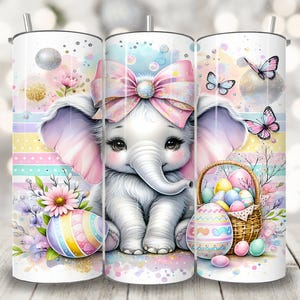 May include: Three white stainless steel tumblers with a pastel pink, blue, and yellow Easter theme. The center tumbler features a cute cartoon elephant with a pink bow, surrounded by butterflies and Easter eggs. The tumblers are perfect for spring.