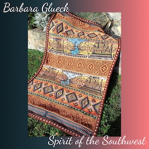 May include: A brown and orange crocheted blanket with a Southwestern design featuring a landscape scene and geometric patterns. The blanket is labeled "Spirit of the Southwest" and "Barbara Glueck".