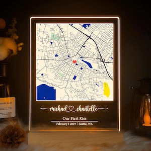 May include: Illuminated map art featuring a detailed city map with a red heart marking a location. The text reads "michael & chantelle, Our First Kiss, February 5 2019 | Seattle, WA". The map is encased in a glowing frame.