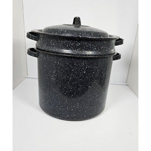 May include: A black and white speckled enamel double boiler with a lid. The boiler has two handles on each side.
