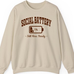 Social Battery 1% shirt, hoodie, sweatshirt, introvert humor tee, social anxiety quote, funny burnout design, exhausted but surviving top