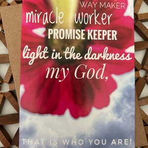 May include: A pink and white floral card with the text "WAY MAKER miracle worker PROMISE KEEPER light in the darkness my God, THAT IS WHO YOU ARE!"