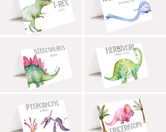 May include: Set of six printable dinosaur food labels featuring watercolor illustrations of different dinosaurs. The labels include text such as "T-Rex Bites", "Stegosaurus Spikes", "Tanystropheus Watering Hole", "Herbivore Veggie Sticks", "Pterodactyl Wings", and "Triceratops Treats".