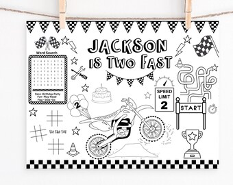 May include: Black and white printable coloring page featuring a motocross bike, a birthday cake, balloons, and a word search puzzle. The text "JACKSON IS TWO FAST" is at the top of the page.
