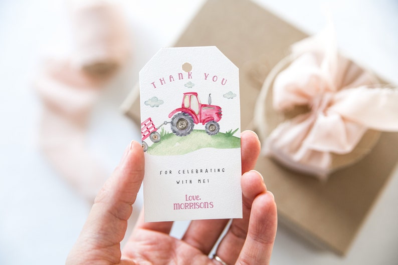 May include: Red and white thank you tag with a watercolor illustration of a red tractor pulling a wagon. The tag says "Thank You for celebrating with me. Love, Morrisons."