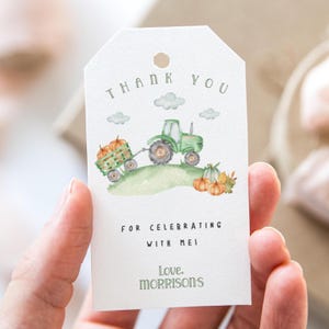 May include: A white tag featuring a watercolour illustration of a green tractor and pumpkins. The tag has the words "THANK YOU", "FOR CELEBRATING WITH MEI" and "Love, Morrisons" printed on it.