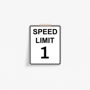 May include: A white speed limit sign with black text and border. The sign reads "SPEED LIMIT 1".