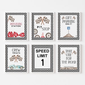 May include: Six printable signs with a checkered black and white background. The signs feature racing-themed text and images, including a pit stop, refueling station, crew treats, speed limit, gift parking only, and take one for the road.