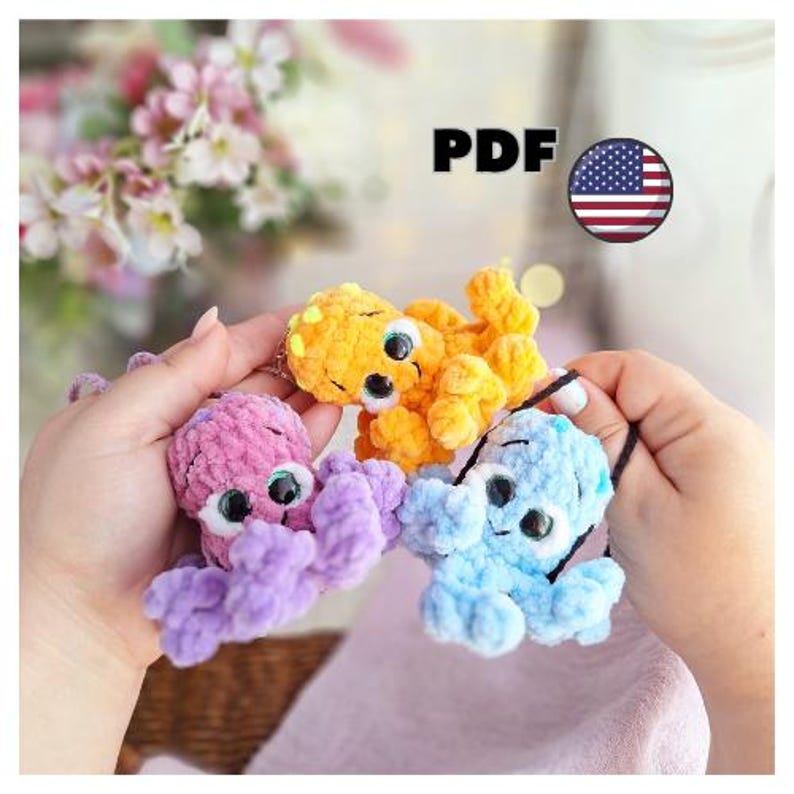May include: Three colourful crochet octopus toys in shades of purple, orange, and blue. Each octopus has large, googly eyes and a black string loop. The word "PDF" is visible in the image, along with a US flag.