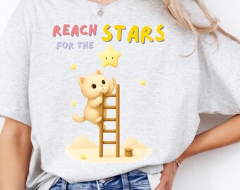 Camiseta con diseño de gato adorable alcanzando las estrellas, regalo para amantes de los animales.