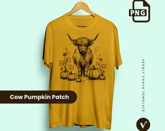 May include: Mustard yellow t-shirt featuring a black illustration of a Highland cow with pumpkins and vines. The text "Cow Pumpkin Patch" is displayed on a black banner at the bottom. The shirt is hanging on a wooden hanger.