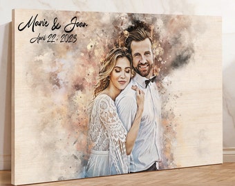 May include: A watercolour painting of a couple on their wedding day. The couple are embracing, with the woman in a white lace dress and the man in a white shirt and black bow tie. The painting has a soft, romantic feel and is set against a background of watercolour washes in shades of pink, blue, and brown. The text "Marie & Joan April 22, 2023" is written in black script at the top of the painting.