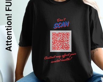 May include: Black t-shirt with a red and blue graphic that says "Don't Scan" and features a QR code. The text below the QR code reads "Content may affect your mental health!"
