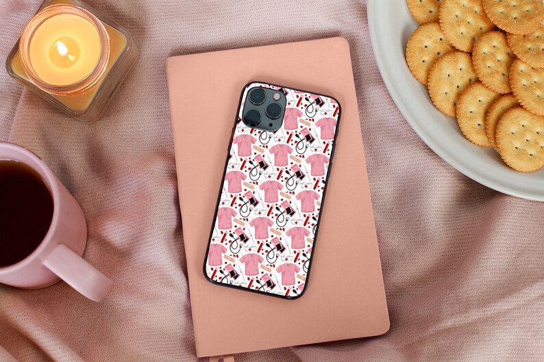 May include: A white iPhone case with a pink and red pattern of medical tools and scrubs. The case has a black border and a camera cutout.
