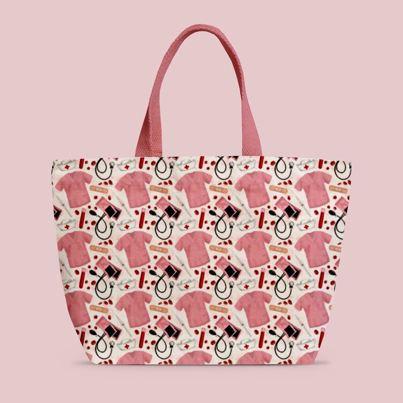May include: A pink tote bag with a white background and a repeating pattern of pink scrubs, red blood drops, bandages, and medical equipment.