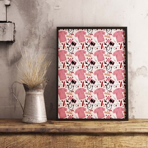 May include: A black framed print with a repeating pattern of pink scrubs, medical supplies, and red drops of blood. The print features a white background.