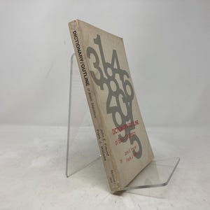 May include: A white book with a red title, "Dictionary/Outline of Basic Statistics". The cover features large, gray numbers.