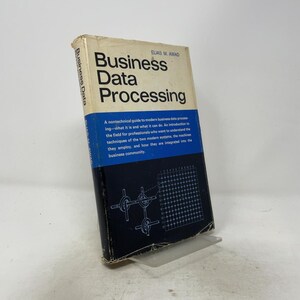 May include: A hardcover book titled Business Data Processing by Elias M. Awad. The cover features a white top section with black text, a blue middle section with descriptive text, and a dark blue bottom section with a white grid diagram.