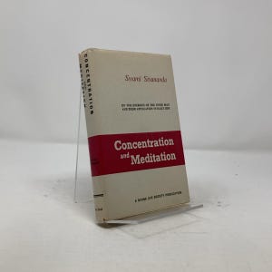 May include: A white book with a red spine titled "Concentration and Meditation" by Swami Sivananda. The book is a Divine Life Society Publication and discusses the energies of the inner man and their application in daily life.