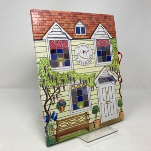 May include: A yellow and red illustrated children's book with the title "My Very Own Playhouse". The cover features a yellow house with a red roof, windows, and a door. There are flowers and vines around the house.