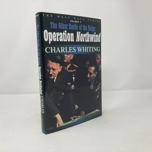 May include: A book cover with a black and white photo of four men in military uniforms. The title of the book is "The Other Battle of the Bulge: Operation Northwind" by Charles Whiting.