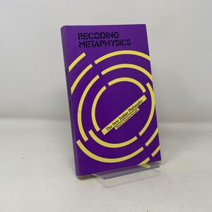 Peut inclure: Un livre violet avec le titre "Recoding Metaphysics: The New Italian Philosophy" et un motif géométrique jaune et violet sur la couverture.