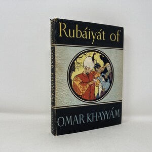 May include: A hardcover book titled "Rubáiyát of Omar Khayyám" with a black cover and gold lettering. The book features a circular illustration of figures in a Middle Eastern setting. The book is a vintage edition.