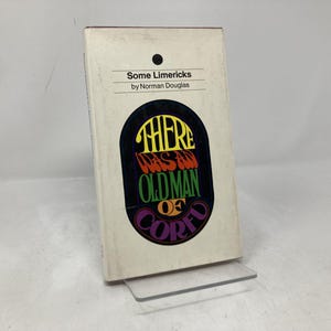 May include: A vintage book titled "Some Limericks" by Norman Douglas. The cover features a black oval with the words "THERE WAS AN OLD MAN OF CORFU" in colorful, stylized lettering. The book is propped up on a clear plastic stand.