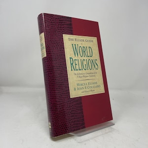 May include: A hardcover book titled The Eliade Guide to World Religions by Mircea Eliade and Ioan P. Couliano with Hillary S. Wiesner. The cover features a deep red color with a textured dark purple spine and a cream-colored central text box.