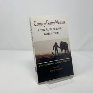 May include: A book titled "Cowboy Poetry Matters: From Abilene to the Mainstream" with a cover image of a cowboy on horseback. The book is a collection of contemporary cowboy writing edited by Robert McDowell.