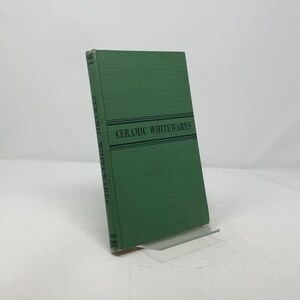 May include: A green hardcover book titled "Ceramic Whitewares".