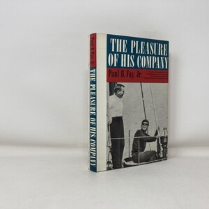 May include: A hardcover book titled "THE PLEASURE OF HIS COMPANY" by Paul R. Fay, Jr. The book's cover features a photograph of two men on a boat. The spine of the book is white with the title printed vertically.