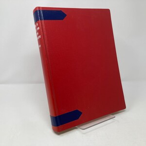 May include: A red hardcover book with a blue spine and a blue band at the top and bottom. The title of the book is "How to Use Your Microscope".