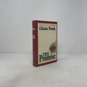 May include: A hardcover book titled "The Promise" by Chaim Potok. The book has a burgundy spine and a cream-colored cover with the title and author's name in dark brown. The cover features a silhouette of people.