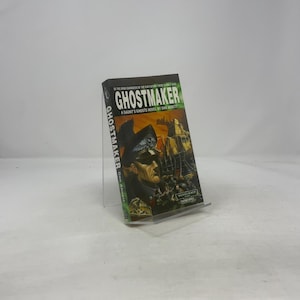 May include: A copy of the book "Ghostmaker" by Dan Abnett. The cover art depicts a military figure and a futuristic setting. The book is part of the Gaunt's Ghosts series, with text on the spine.