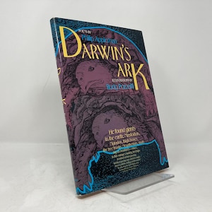May include: A book titled "Darwin's Ark" by Philip Appleman with illustrations by Rudy Pisano. The cover features a dark purple and blue illustration of a creature with a large head and a long, winding body.