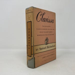 May include: A vintage book cover with a pink background and the title "Clarissa" in a black cursive font. The book is by Samuel Richardson and is the history of Clarissa Harlowe, the first and one of the most famous heroines of the English novel.