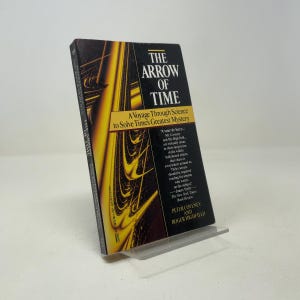 May include: A hardcover book titled The Arrow of Time: A Voyage Through Science to Solve Time's Greatest Mystery by Peter Coveney and Roger Highfield. The cover features a black background with a swirling yellow and gold abstract graphic design.