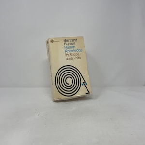 May include: A paperback book titled "Human Knowledge Its Scope and Limits" by Bertrand Russell. The cover is beige with black spiral design and blue text. The book is in good condition.