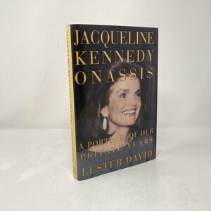 May include: A hardcover book titled "Jacqueline Kennedy Onassis: A Portrait of Her Private Years" by Lester David. The book features a portrait of Jacqueline Kennedy Onassis on the cover, with gold lettering on a black background.