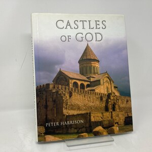 May include: Book cover with the title "Castles of God" and an image of a stone church with a tall spire. The author is Peter Harrison.