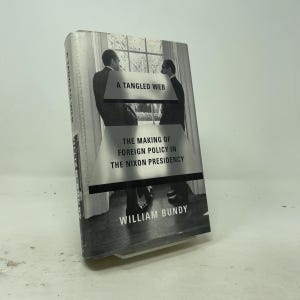 May include: A hardcover book titled A Tangled Web: The Making of Foreign Policy in the Nixon Presidency by William Bundy. The black and white cover features a photograph of two men in suits standing near a window, with bold text.