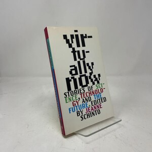 May include: A book titled Virtually Now: Stories of Science, Technology, and the Future, edited by Jeanne Schinto. The cover features large, black, pixelated text on a white background, with additional text in green, red, and blue.