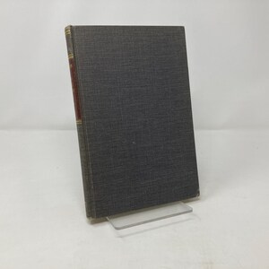 May include: A dark gray hardcover book with a gold spine and a red label on the spine.
