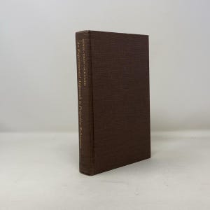 May include: A brown hardcover book with gold lettering on the spine. The title is "An Experimental Approach to Projective Techniques" by Zubin, Eron, and Schmier.