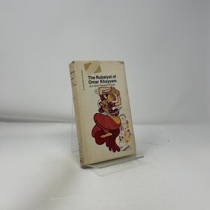 May include: A vintage copy of "The Rubaiyat of Omar Khayyam and other Persian Poems" book. The cover features an illustration of a figure in red and gold clothing. The book is in a clear display stand.