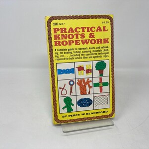 May include: A yellow book titled "Practical Knots & Ropework" with a price of $9.95. The cover features illustrations of various knots and ropework techniques.